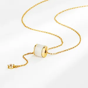Detail view of gold S925 silver necklace with cylinder stone pendant and star charm