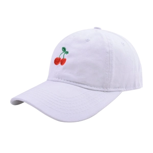 Detailed close-up of vibrant red cherry embroidery on white washed cotton baseball cap