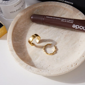Minimalist 18k gold plated stainless steel rings set with hammered texture on marble