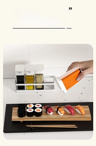 Macro view of food-grade seasoning shaker pouring spices onto sushi in a kitchen