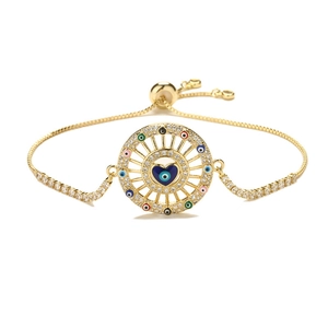 Adjustable golden heart evil eye bracelet with colorful zircons on white background