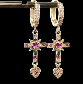 Detailed macro view of cross-shaped heart earrings with colorful zircon stones
