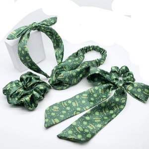 Detailed view of Saint Patrick's Day 4-piece hair accessory set with shamrock satin patterns