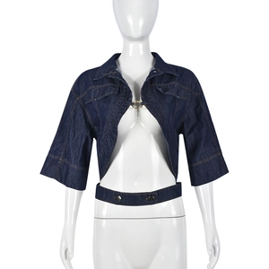 Detail of dark blue denim crop top featuring metal ring buckle and matching waist belt