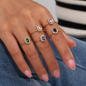 Detail of adjustable gold-plated rings featuring colorful oval cubic zirconia stones