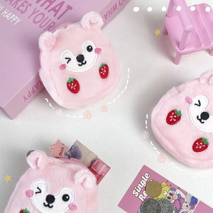 Close-up of pink plush strawberry hamster coin purses showing coins and interior storage