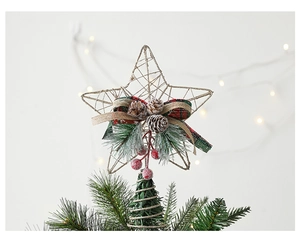Detail of Christmas tree topper with twine star, pine cones and red berries decoration