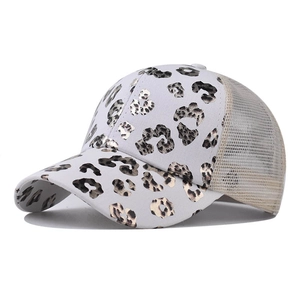 Detail of white baseball cap featuring metallic leopard print and breathable mesh back