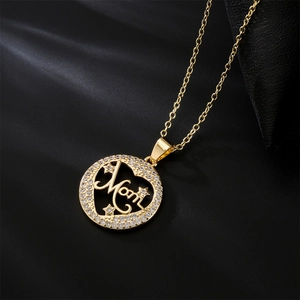 Golden MOM pendant necklace with sparkling cubic zirconia on a black textured background