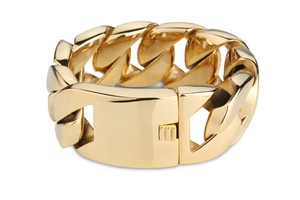 Detailed view of bold gold-plated stainless steel Cuban link bracelet with glossy finish
