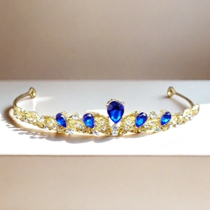 Luxurious gold bridal tiara with blue water-drop gems and sparkling clear rhinestones