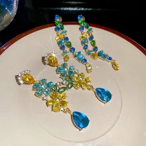 Floral teardrop dangle earrings with vibrant colorful crystals and sparkling diamonds