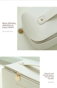 Close-up of cream leather toiletry bag with golden zipper and neat stitching details