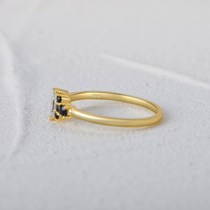 Detail of S925 sterling silver ring with marquise opal and black accent stones