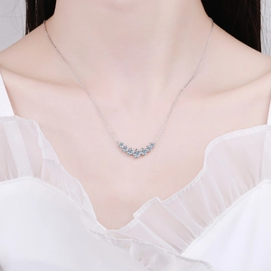 S925 sterling silver smile necklace with D color moissanite worn by a model