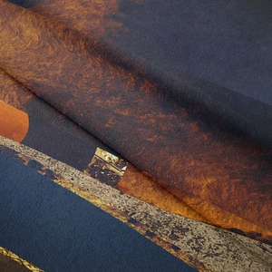 Close-up of abstract mountain tapestry showing thick textured fabric and dark blue tones