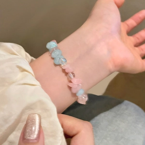 Detail of pink and light blue irregular natural stone beads on a minimalist beaded bracelet