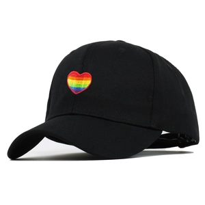 Black baseball cap with rainbow heart embroidery shown from a 45-degree side angle
