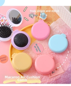 Macro shot of colorful macaron-style folding hairbrushes with built-in makeup mirrors
