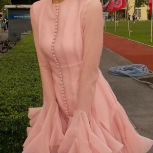 Pink long sleeve dress with button-front detail and layered ruffle hemline