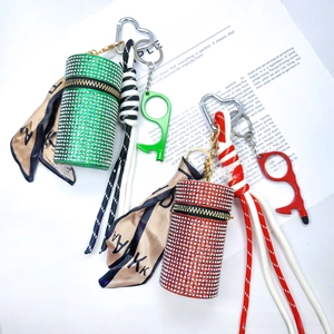 Detail of rhinestone heart charms and woven lanyards on luxury green and red scent cases