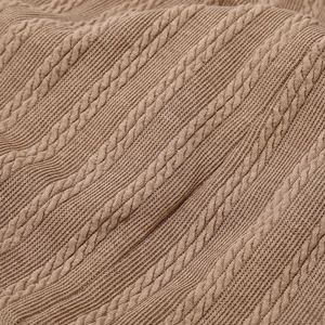 Macro shot of brown cable knit fabric showing textured wool texture and warm stitch detail