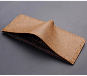 Detail showing the inner zipper pocket and lychee texture of the brown leather wallet