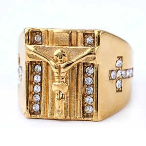 Macro shot of gold-plated punk ring featuring a religious cross and white rhinestones
