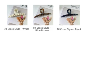 Detailed view of large acetate claw clips in white, blue-brown, and black colorful patterns