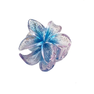Detailed macro view of 4cm transparent glitter plumeria hair claw in blue gradient
