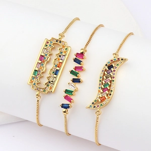 Detail of colorful cubic zirconia bracelets with adjustable slide closure in gold finish