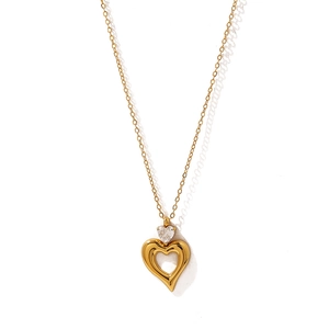 Macro shot of 18K gold hollow heart necklace with shimmering zircon stone detail