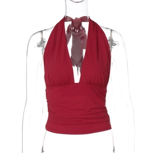 Detail of red halter V-neck top showing elegant waist pleats and elastic smooth fabric