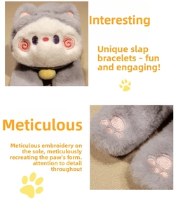 Detail of plush cat toy showing pink paw embroidery and soft grey faux fur texture