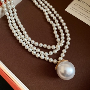 Elegant multi-layer pearl necklace with a large pendant and vintage golden petal base