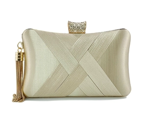 Detail of champagne gold evening clutch featuring tassel and crystal-inlaid metal buckle