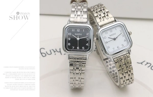 Detail view of NAIDU square quartz watches with silver stainless steel bands and numerals