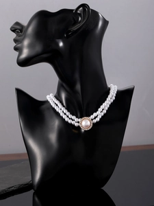 Elegant double-layer white pearl necklace with gold diamond-set pendant on black neck bust