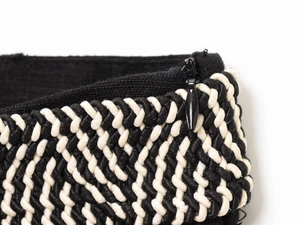 Macro shot of invisible zipper and black-white woven texture on linen blend dress