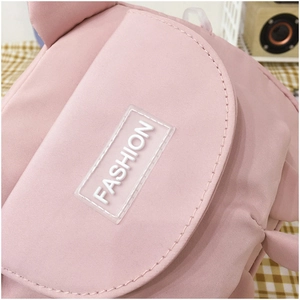 Close-up of pink canvas bag showing neat stitching and white silicone FASHION label