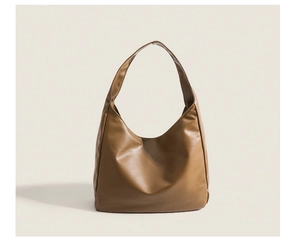 Close-up of the vintage brown synthetic leather shoulder bag with seamless stitching