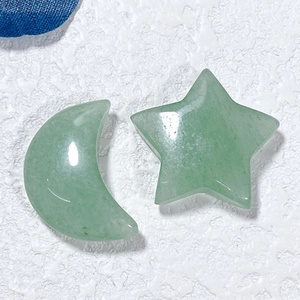 Macro shot of natural green crystal carvings in star and moon shapes for home decor
