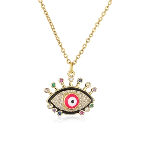Detail of gold evil eye necklace with colorful zircons and black enamel dripping oil finish