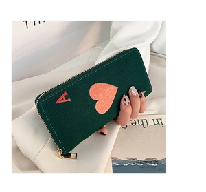 Detail of dark green canvas wallet with Ace of Hearts design and gold zipper closure