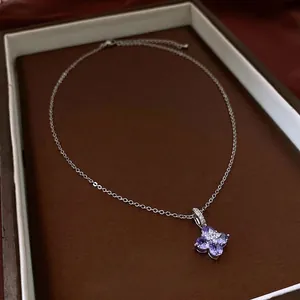 Elegant silver flower pendant necklace with purple marquise zircon stones on brown leather box