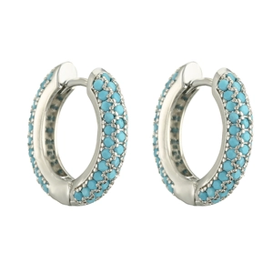 Detail view of silver hoop earrings featuring pavé-set vibrant blue turquoise gemstones