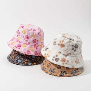 Plush bucket hat with colorful paw prints in pink white gray and brown faux fur