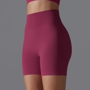 Close-up of seamless ribbed high waistband and stretchy plum purple yoga shorts fabric