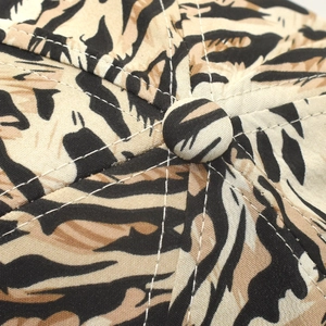 Close-up of animal tiger print baseball cap showing contrast stitching and top button