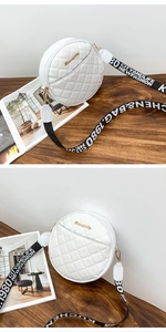 Detail of white round quilted shoulder bag featuring gold logo and wide letter strap